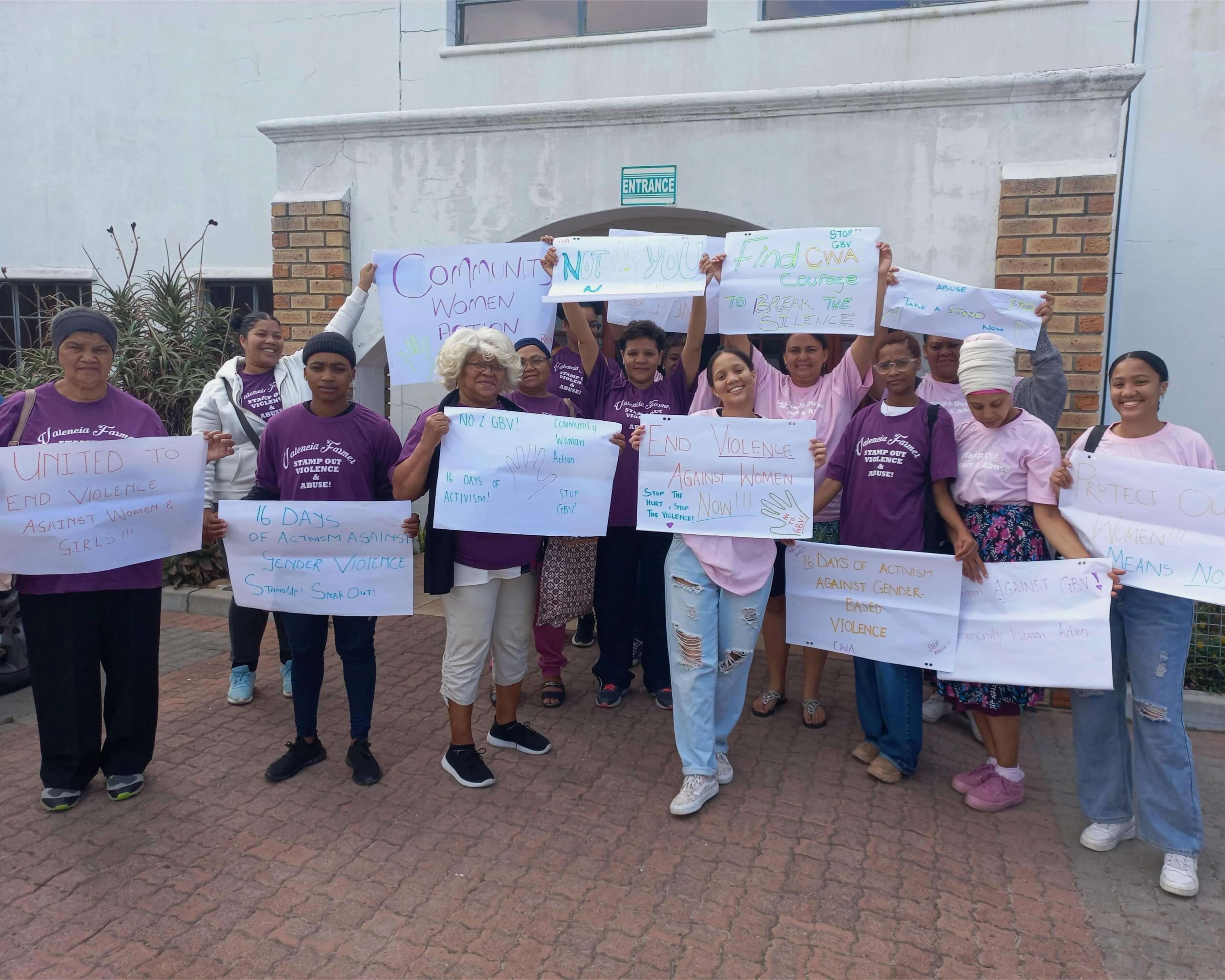 Woman raising GBV awareness posters